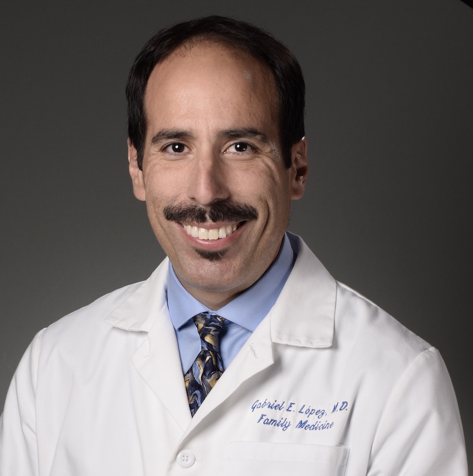 A headshot of Gabriel E. López, MD