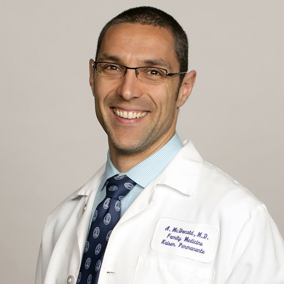 A headshot of Alex McDonald, MD, CAQSM, FAAFP