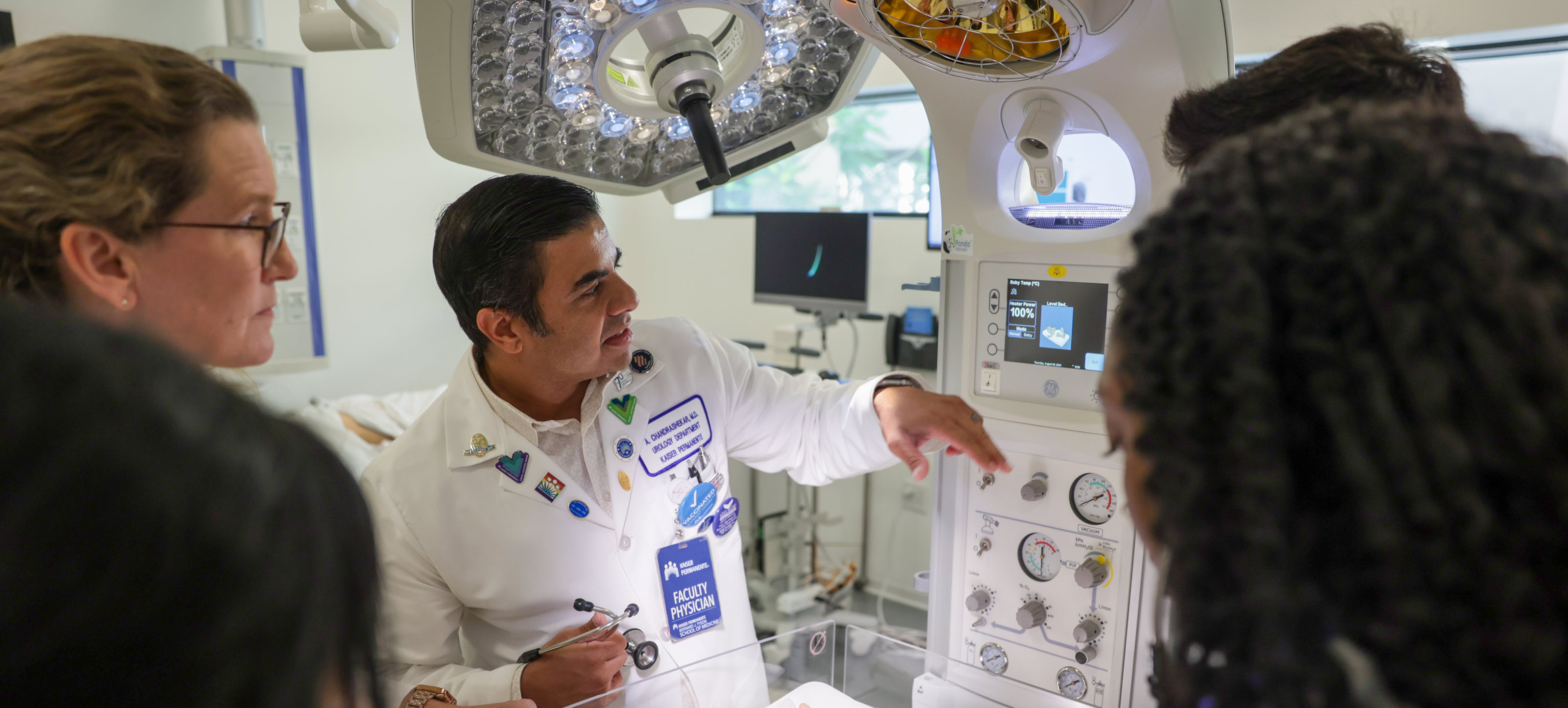 A faculty member and students in the Simulation Center