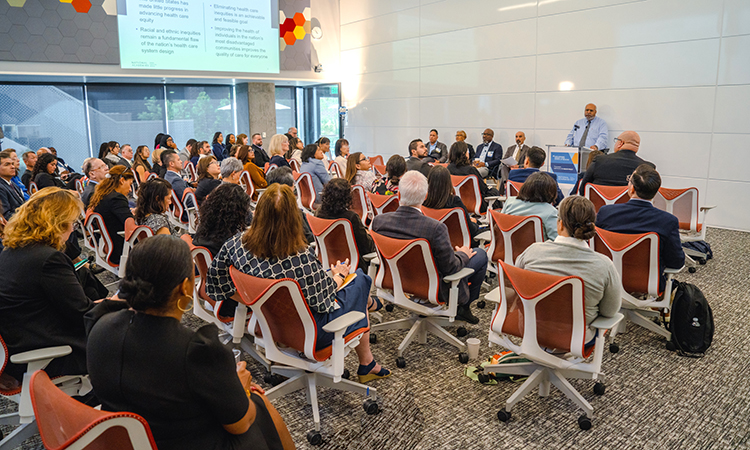 Panelists share their findings on health inequities with attendees during the forum.