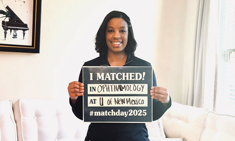 KPSOM student Shannon Moore holding up her Match Day sign for Ophthalmology.