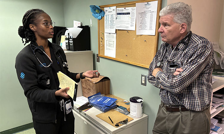 Student Destiny Rochester and faculty adviser Dr. Marc LaRiviere, discuss a patient’s status at the Student-Run Clinic.