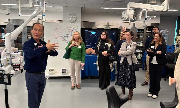 Frank Thai, Director of Biological Technology, conducts a tour of the KPSOM Anatomy Resource Center for the consortium attendees.