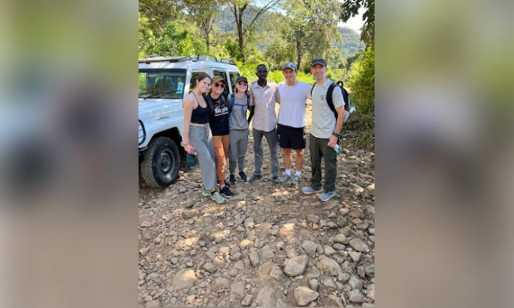 KPSOM students join Dr. Jeff Brettler and a guide (at center) for a hike at Torok Falls during a day trip leading up to the AMPATH exchange program in Eldoret, Kenya.