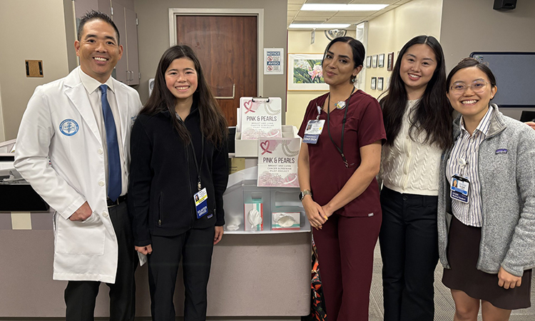 Dr. Jeffrey Velotta picks up smoking questionnaires at the Kaiser Permanente Oakland Mammogram Clinic along with high school student volunteer Marikit Flores; Maryam Soroush, Kaiser Permanente Radiologic Technologist Lead; student volunteer Lauren Leong; and KPSOM student researcher Elaine Liang.