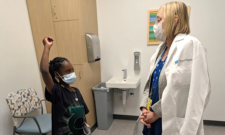 Dr. Pamela Becker (at right) shares a moment with Donte Cofield’s daughter