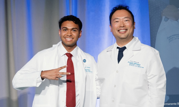 Student Talha Siddiqi and Kevin Chang, MD, Clinical Assistant Professor of Clinical Science, onstage at the ceremony.